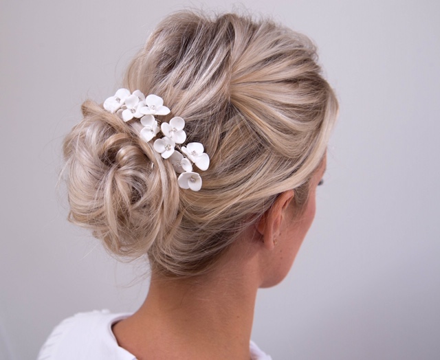 Bridal updo with floral accessory